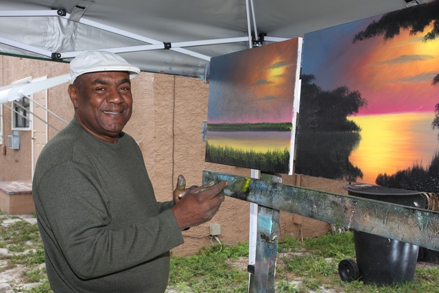 Al Black paints a sunset scene at his home in Fort Pierce